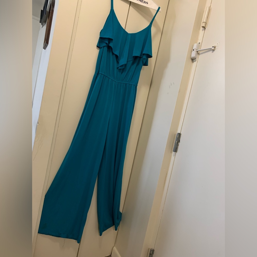 Pretty jumpsuit with ruffle collar tiny straps and elastic waist comfy material.